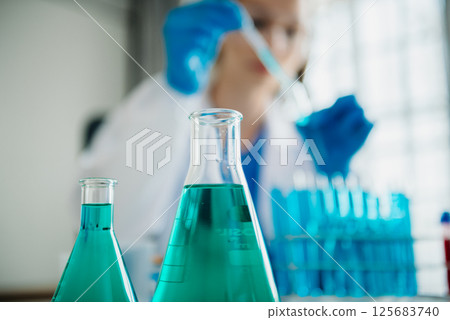 Modern medical research laboratory. female scientist working with micro pipettes analyzing biochemical samples, advanced science chemical laboratory for medicine. 125683740