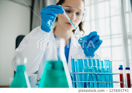 Modern medical research laboratory. female scientist working with micro pipettes analyzing biochemical samples, advanced science chemical laboratory for medicine. 125683741