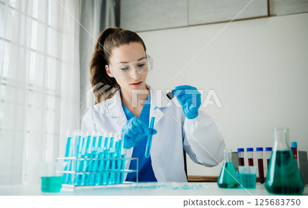 Modern medical research laboratory. female scientist working with micro pipettes analyzing biochemical samples, advanced science chemical laboratory for medicine. 125683750