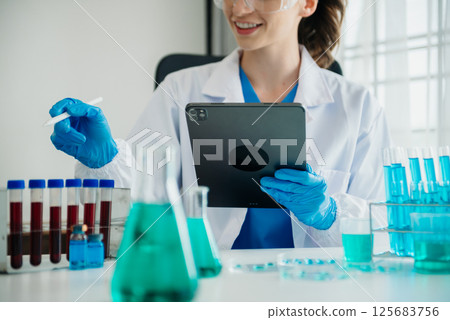 Coronavirus COVID-19 medical test vaccine research and development concept.in a chemistry lab. Coronavirus COVID-19 medical test vaccine research and development concept.in a chemistry lab. 125683756