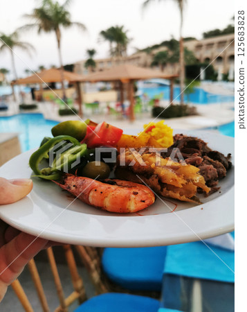 fried potatoes, meat and vegetable 125683828