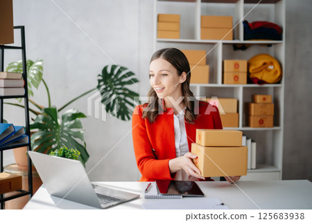 Startup small business SME, Entrepreneur owner woman using smartphone or tablet taking receive and checking online purchase shopping order Startup small business SME, Entrepreneur owner woman using smartphone or tablet taking receive and checking online purchase shopping order 125683938