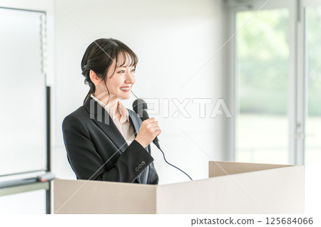 Businesswoman giving a presentation at a meeting, training session, or presentation Businesswoman giving a presentation at a meeting, training session, or presentation 125684066