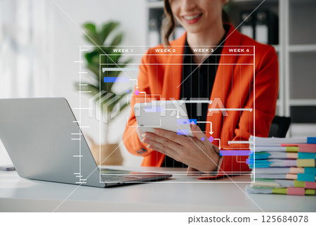 Project manager working and update tasks with milestones progress planning and Gantt chart scheduling diagram. business working with smart phone, tablet and laptop 125684078