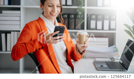 businesswoman working with digital tablet computer and smart phone with financial business strategy layer effect on desk 125684117
