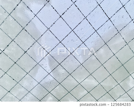 Stock Photo: Image of snow and water droplets on a window 125684283