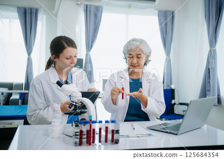 Medical team having a meeting with doctors. Young scientists conducting research investigations 125684354