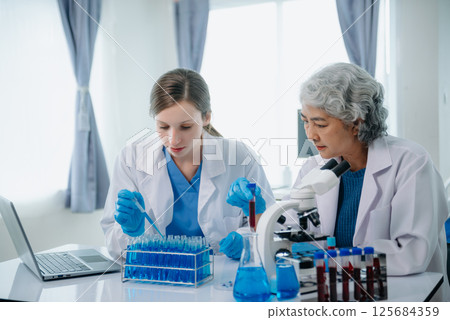 Medical team having a meeting with doctors. Young scientists conducting research investigations Medical team having a meeting with doctors. Young scientists conducting research investigations 125684359