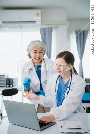 Hospital Ward. Doctor Talks With Professional Head Nurse or Surgeon, They Use Digital tablet Computer. Diverse Team of Health Care Specialists Discussing Test Result 125684432