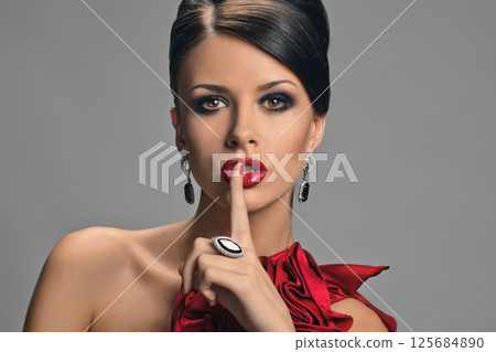 Woman touching lips Woman touching lips 125684890