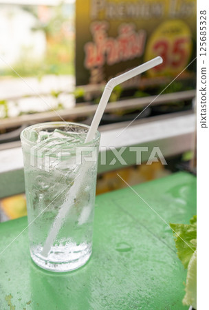 Drinking water in a clean glass, straw, white, hygienic, healthy. Drinking water in a clean glass, straw, white, hygienic, healthy. 125685328