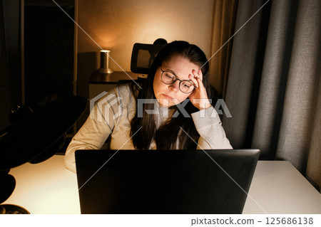 Tired new entrepreneur trying to deal with business problems. Upset businesswoman feeling tired of unsuccess selling products. Woman with laptop. Online business concept. 125686138