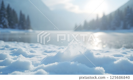 Serene winter landscape with glistening snow, calm lake and majestic mountains 125686840