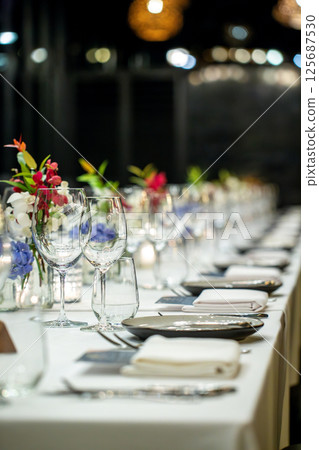 Elegant Dinner Table with Floral Decorations 125687530