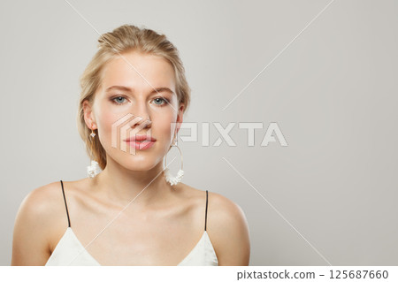 Lovely blond woman looking at camera. Beauty young adult person portrait Lovely blond woman looking at camera. Beauty young adult person portrait 125687660