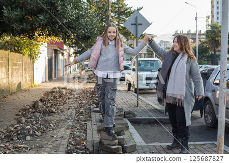 Portrait of mother and daughter outdoors together. Family lifestyle portrait Portrait of mother and daughter outdoors together. Family lifestyle portrait 125687827