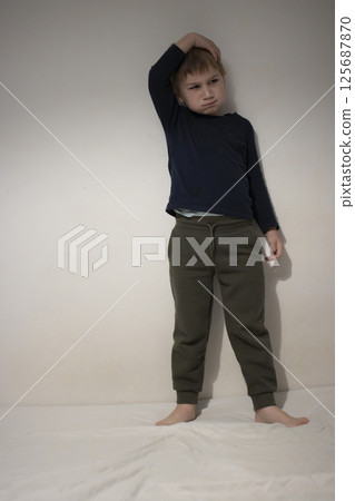 Thoughtful child scratching head expressing confusion and doubt Thoughtful child scratching head expressing confusion and doubt 125687870