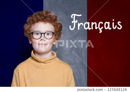 Young boy on French flag with the inscription Francais in French. Education and study language Young boy on French flag with the inscription Francais in French. Education and study language 125688126