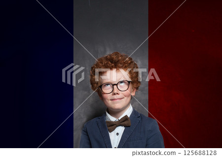 Portrait of child boy on French flag background. Education, travel, school, camp and study language Portrait of child boy on French flag background. Education, travel, school, camp and study language 125688128