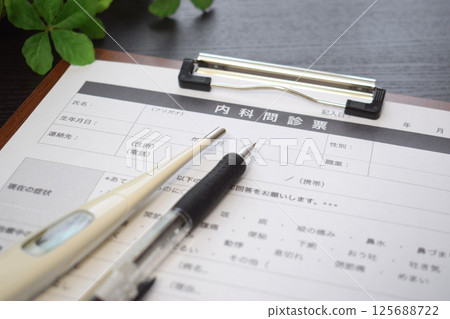 Questionnaire and thermometer Questionnaire and thermometer 125688722