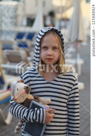 Portrait of cheerful blond child girl outdoors 125688924