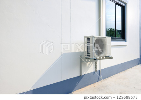 Condenser unit outside home. Condenser unit outside home. 125689575