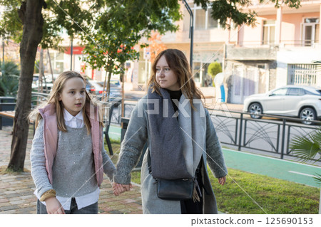 Loving family. Playful child girl and happy mother, outdoors portrait 125690153