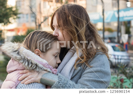 Loving woman hugging child. Mother and daughter together. Childhood, happiness, love and family 125690154