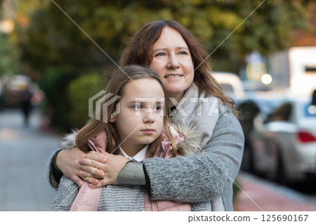 Happy woman hugging child. Mother and daughter together. Childhood, happiness Happy woman hugging child. Mother and daughter together. Childhood, happiness 125690167