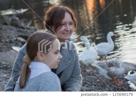 Happy family having fun in park. Mother and daughter portrait 125690179