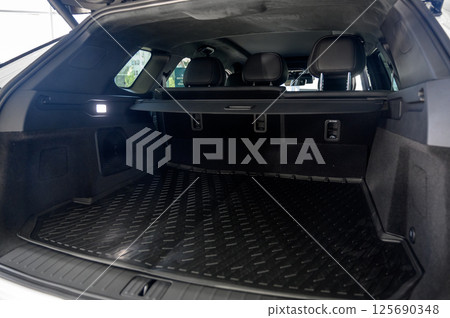 Large black empty car trunk. Open car trunk close up Large black empty car trunk. Open car trunk close up 125690348