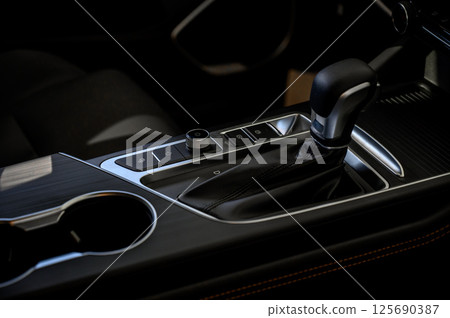 Automatic transmission selector in the interior of a modern car. 125690387