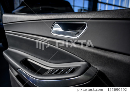 Car door with door handle and window control and adjustment button Car door with door handle and window control and adjustment button 125690392