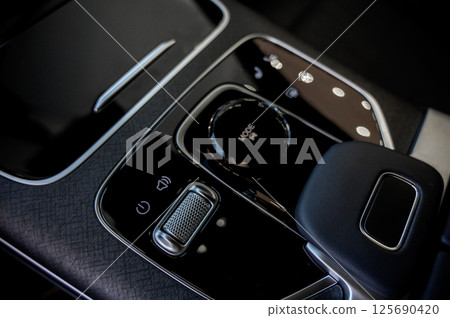 Automatic transmission selector in the interior of a modern car. 125690420