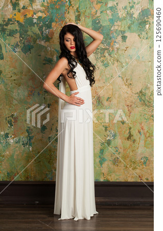 Glorious young female model brunette looking at camera indoor, full length portrait Glorious young female model brunette looking at camera indoor, full length portrait 125690460