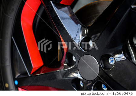 Car wheel with brake calipers and stylish design. Car wheel with brake calipers and stylish design. 125690476