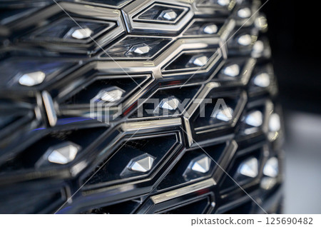 Close-up of the facade of a new car in a car showroom. The radiator grille of a car 125690482