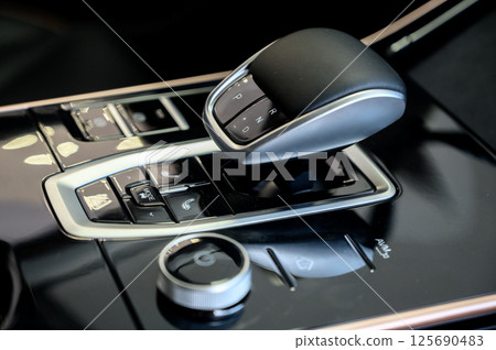 Automatic transmission selector in the interior of a modern car. 125690483