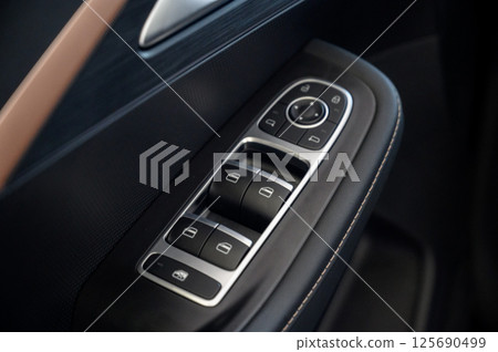Car door with door handle and window control and adjustment button 125690499