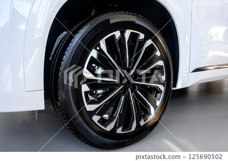Car wheel with brake calipers and stylish design. 125690502