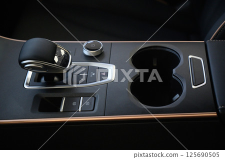 Automatic transmission selector in the interior of a modern car. Automatic transmission selector in the interior of a modern car. 125690505