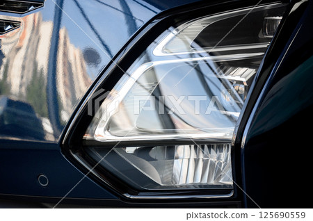 Close up of the headlight of a new modern car Close up of the headlight of a new modern car 125690559