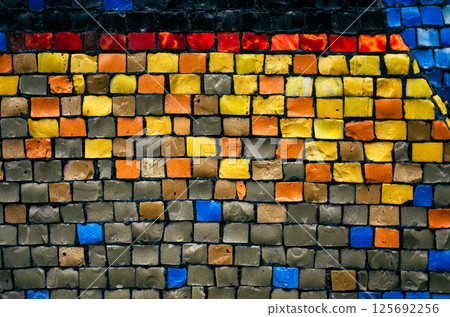 Abstract geometric mosaic made of square tiles in red and yellow, flat lay texture with copy space. Bright ceramic wall with decorative vintage pattern and surface cracks Abstract geometric mosaic made of square tiles in red and yellow, flat lay texture with copy space. Bright ceramic wall with decorative vintage pattern and surface cracks 125692256