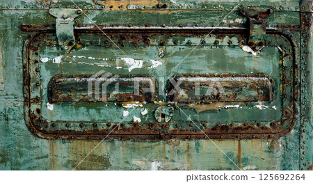 Close-up of old rusty industrial hatch with bolts and metal handle on a grunge textured panel. Ideal background for engineering, machinery and industrial design Close-up of old rusty industrial hatch with bolts and metal handle on a grunge textured panel. Ideal background for engineering, machinery and industrial design 125692264