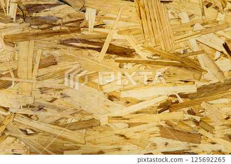 Wooden OSB panel surface with visible texture for wall, floor or ceiling design. Eco-friendly background for decor and renovation projects 125692265