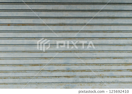 Rusty metal roller shutter garage door texture Rusty metal roller shutter garage door texture 125692410