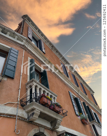 Old European building with balconies at sunset Old European building with balconies at sunset 125692411