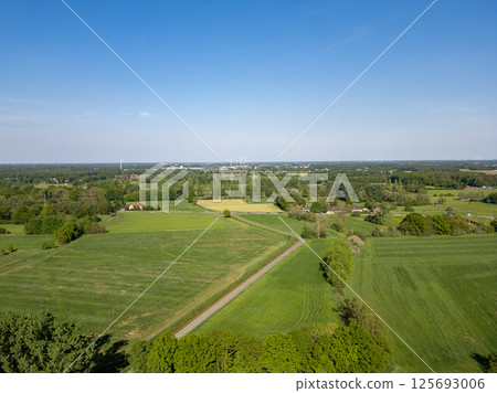 Expansive Lush Green Fields Sprawling Beneath a Clear and Beautiful Blue Sky on a Lovely Day 125693006