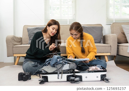 Travel preparation with friends: Packing and planning vacation 125693237