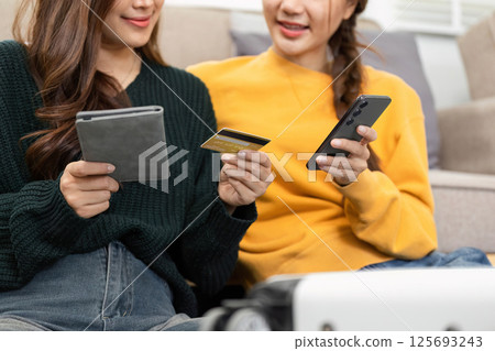 Online shopping experience: Friends exploring digital payments together Online shopping experience: Friends exploring digital payments together 125693243